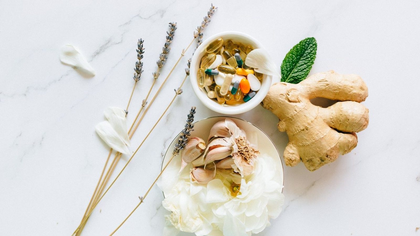 Flatlay of collagen-supporting foods and supplements on a marble surface