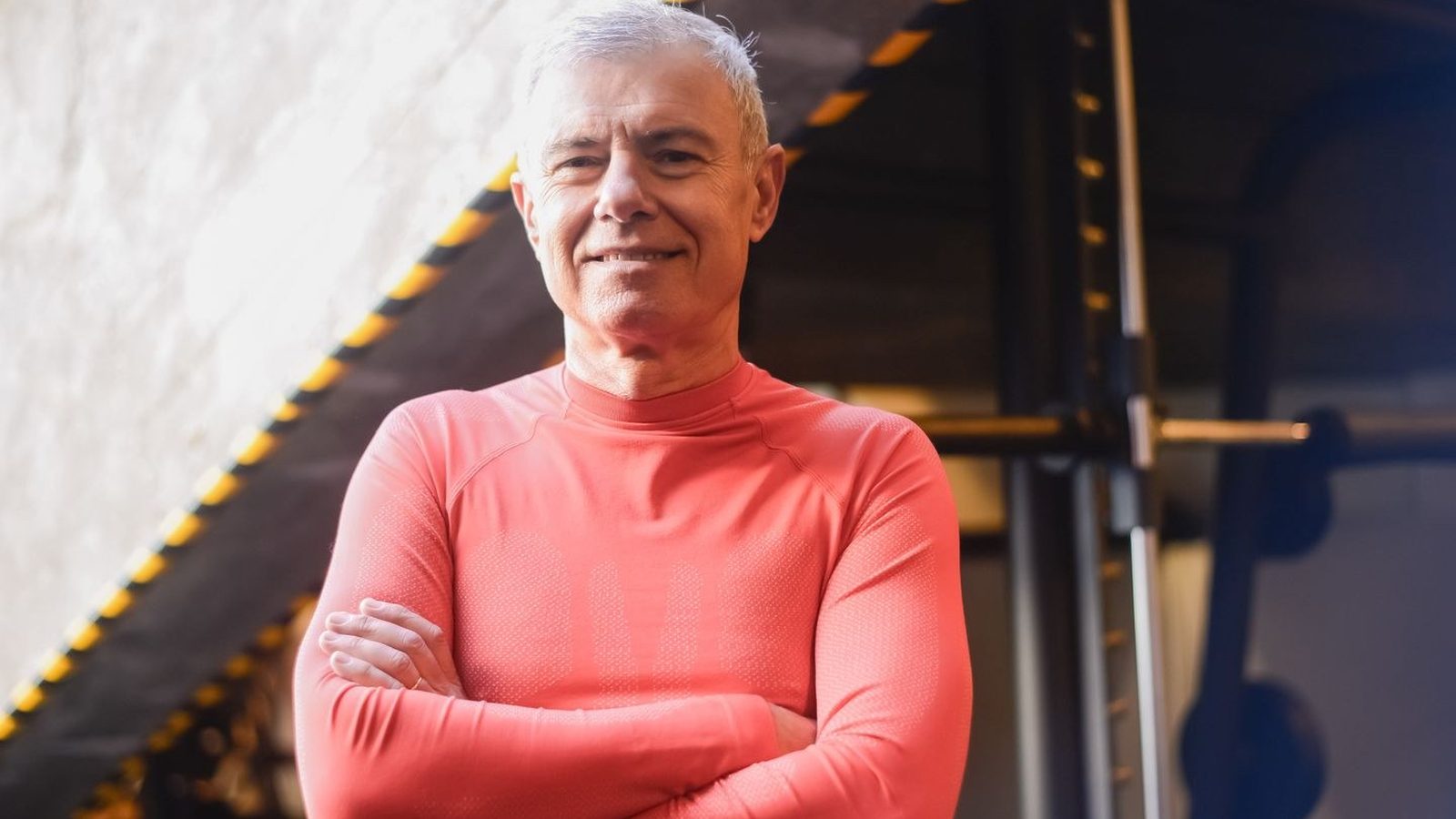 Confident middle-aged man in a gym setting, reflecting strength and energy